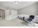 Neutral Bedroom featuring paneled walls, white trim, soft carpet, and a white crib with an accent chair at 16714 Hammock Creek Pl, Charlotte, NC 28278