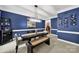 Elegant dining room with bold blue walls, white trim, modern lighting, and a wine rack at 16714 Hammock Creek Pl, Charlotte, NC 28278