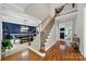 Grand foyer featuring hardwood floors, a staircase with wrought iron spindles, and a view of the dining room at 16714 Hammock Creek Pl, Charlotte, NC 28278