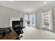 Bright office space with a fireplace and plenty of natural light from three large windows at 16714 Hammock Creek Pl, Charlotte, NC 28278