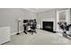 Office with fireplace, neutral colors, desk, and natural light at 16714 Hammock Creek Pl, Charlotte, NC 28278