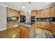 Kitchen featuring an island cooktop, granite counters, wood cabinets, and stainless steel appliances at 16714 Hammock Creek Pl, Charlotte, NC 28278