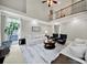 Comfortable living room features a fireplace, tall ceilings, large windows, and neutral decor at 16714 Hammock Creek Pl, Charlotte, NC 28278