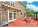 Relaxing brick patio with a table and chairs under an awning, perfect for outdoor entertaining at 16714 Hammock Creek Pl, Charlotte, NC 28278