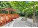 Beautiful backyard with a wooden deck, pergola, brick patio, and lovely landscaping at 1734 Seifert Cir, Charlotte, NC 28205