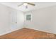 This bright bedroom features hardwood floors, natural light, and a ceiling fan at 1734 Seifert Cir, Charlotte, NC 28205