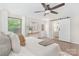 This cozy bedroom features hardwood floors, a ceiling fan, and an ensuite bathroom at 1734 Seifert Cir, Charlotte, NC 28205
