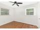 This bright bedroom features hardwood floors, natural light, and fresh white paint at 1734 Seifert Cir, Charlotte, NC 28205