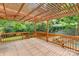 Spacious wooden deck with a pergola overlooking a well-maintained backyard at 1734 Seifert Cir, Charlotte, NC 28205