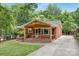 Inviting single story brick home with a well-maintained lawn and covered front porch at 1734 Seifert Cir, Charlotte, NC 28205