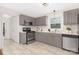 Charming kitchen featuring stainless steel appliances, sleek countertops, and gray cabinetry at 1734 Seifert Cir, Charlotte, NC 28205