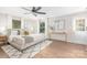 Serene primary bedroom with wood floors, natural light, and a modern ceiling fan at 1734 Seifert Cir, Charlotte, NC 28205