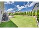 This house has a well-manicured backyard with lush green grass, trees and a wood deck for outside entertainment at 18013 Grey Mossrun Dr, Charlotte, NC 28278