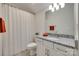 This bathroom features a shower, granite countertops, and white cabinets with decorative faucets and matching towel racks at 18013 Grey Mossrun Dr, Charlotte, NC 28278