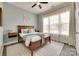 Bedroom with natural light, neutral walls, and a decorative rug over hardwood flooring at 18013 Grey Mossrun Dr, Charlotte, NC 28278