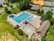 Aerial view of the community pool, complete with lap lanes, a splash pad, seating, and nearby tennis courts at 18013 Grey Mossrun Dr, Charlotte, NC 28278