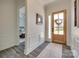 Entryway features beautiful wainscoting, stylish flooring, and a glass-paneled front door at 18013 Grey Mossrun Dr, Charlotte, NC 28278