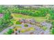 Aerial view of golf course and clubhouse, highlighting the beautifully landscaped greens and manicured grounds at 18013 Grey Mossrun Dr, Charlotte, NC 28278