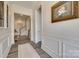 Hallway featuring elegant wainscoting, stylish flooring, and an art-lined walkway at 18013 Grey Mossrun Dr, Charlotte, NC 28278