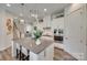 Modern kitchen with stainless steel oven, cooktop, range hood, and large center island at 18013 Grey Mossrun Dr, Charlotte, NC 28278