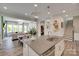 Kitchen island with stainless steel dishwasher, sink, and view of dining and living room at 18013 Grey Mossrun Dr, Charlotte, NC 28278