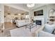 Open-concept living room with fireplace and view of kitchen with a large island and seating at 18013 Grey Mossrun Dr, Charlotte, NC 28278