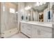 A spacious ensuite bathroom with double sinks, quartz counters, and large glass enclosed shower at 18013 Grey Mossrun Dr, Charlotte, NC 28278