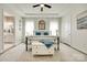 This main bedroom features a trey ceiling, decorative wallpaper, stylish light fixture, and ensuite bath at 18013 Grey Mossrun Dr, Charlotte, NC 28278
