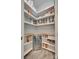 Walk-in pantry with organized shelves, food containers, and a built-in wine cooler at 18013 Grey Mossrun Dr, Charlotte, NC 28278