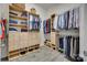 This walk-in closet offers wood shelving, cabinets, drawers, and hanging areas at 18013 Grey Mossrun Dr, Charlotte, NC 28278