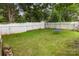 Wide-open backyard with established grass, bordered by a white fence and mature trees at 215 S Shaver St, Salisbury, NC 28144