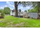 Expansive backyard with lush green lawn, mature trees, and storage shed at 215 S Shaver St, Salisbury, NC 28144