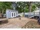 Backyard featuring a modern shed, pea gravel, and a patio, creating a versatile outdoor space at 215 S Shaver St, Salisbury, NC 28144