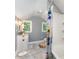 Bright bathroom with a tiled floor, sink with vanity, and a shower with colorful cartoon shower curtain at 215 S Shaver St, Salisbury, NC 28144