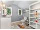 Bright bathroom featuring a tiled floor, a vanity sink, toilet, and a storage unit, enhanced by natural light at 215 S Shaver St, Salisbury, NC 28144