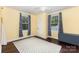 Cozy bedroom with hardwood floors, two windows, light walls and a geometric-pattern rug at 215 S Shaver St, Salisbury, NC 28144