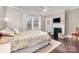 Comfortable bedroom featuring a decorative fireplace, hardwood floors, and natural light at 215 S Shaver St, Salisbury, NC 28144