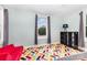 A bright bedroom with a colorful rug, natural light, and red sofa at 215 S Shaver St, Salisbury, NC 28144