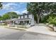 A quaint two-story house featuring a classic white picket fence and a spacious driveway at 215 S Shaver St, Salisbury, NC 28144
