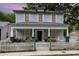 Charming two-story home featuring a welcoming front porch with seating and a classic white picket fence at 215 S Shaver St, Salisbury, NC 28144