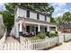 Charming two-story home featuring a cozy front porch and white picket fence at 215 S Shaver St, Salisbury, NC 28144