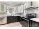 Well-lit kitchen featuring stainless steel appliances, tile backsplash, and stylish cabinetry at 215 S Shaver St, Salisbury, NC 28144