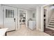 Mudroom with white appliances, tile flooring, and convenient access to the laundry area and staircase at 215 S Shaver St, Salisbury, NC 28144