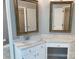 Bathroom vanity featuring marble countertops, sink, chrome faucet, and decorative mirrors at 2222 Raven Dr, Rock Hill, SC 29732