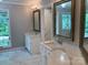 Bathroom with a double vanity, marble countertops, modern faucets, and a large window at 2222 Raven Dr, Rock Hill, SC 29732