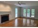 Bright living room featuring a fireplace, hardwood floors, and french doors to the backyard at 2222 Raven Dr, Rock Hill, SC 29732