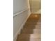 A modern staircase with wooden steps and a white handrail at 2222 Raven Dr, Rock Hill, SC 29732