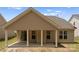Rear view of a home featuring a covered patio supported by white pillars at 2236 Prairie Rd, Concord, NC 28027