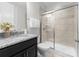 Modern bathroom featuring a glass-enclosed shower, granite vanity, and neutral tile at 2236 Prairie Rd, Concord, NC 28027