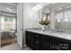 Bathroom features dual sinks, granite countertops, and a view to the adjoining primary bedroom at 2236 Prairie Rd, Concord, NC 28027